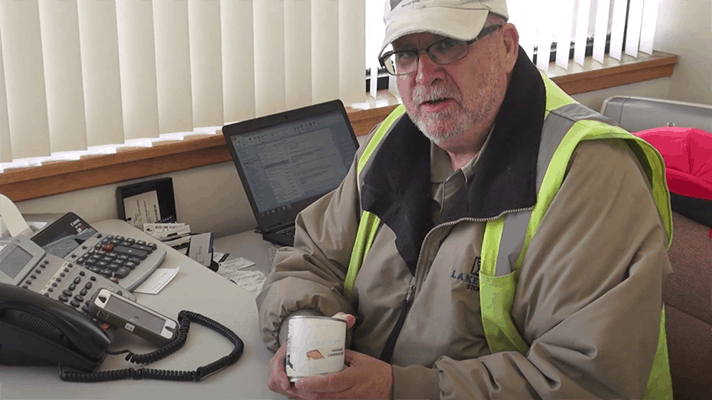 We see how thousands of cans of contaminated product are destroyed and recycled.